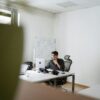 man in black suit sitting on black office rolling chair